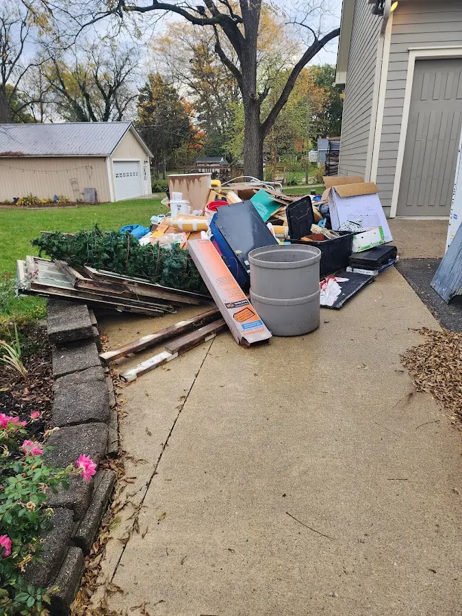 Dumpster being loaded with debris for Commercial Dumpster Rental in Elm Springs